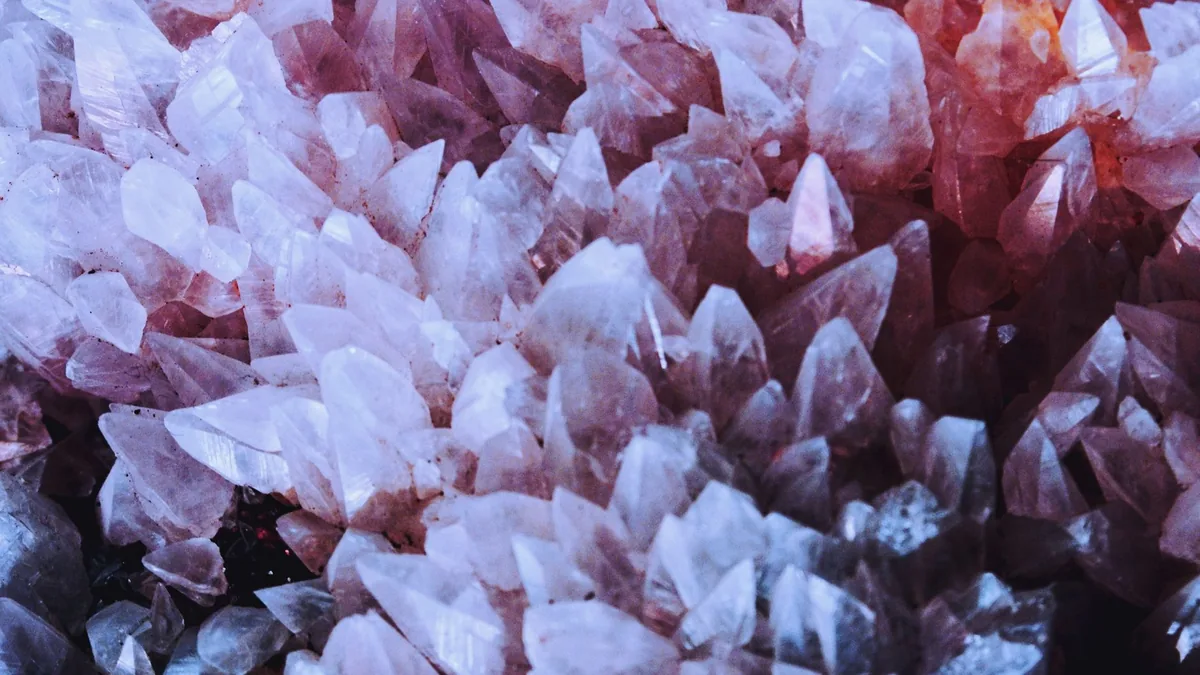 A stunning close-up of naturally occurring pink quartz crystals with sharp details.